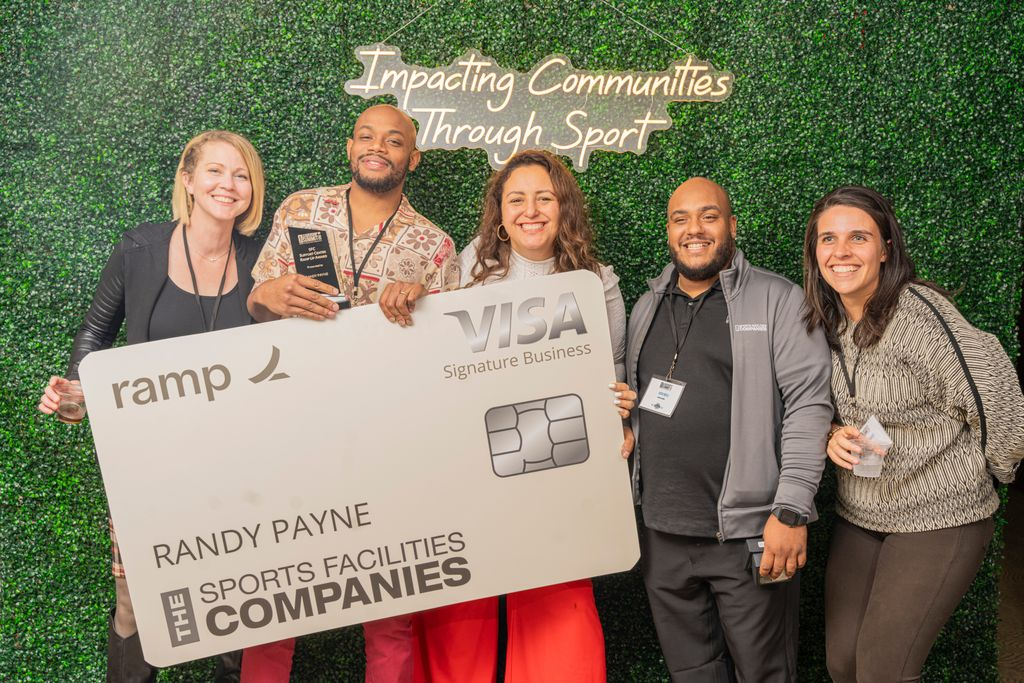 team holding SFC Visa card banner